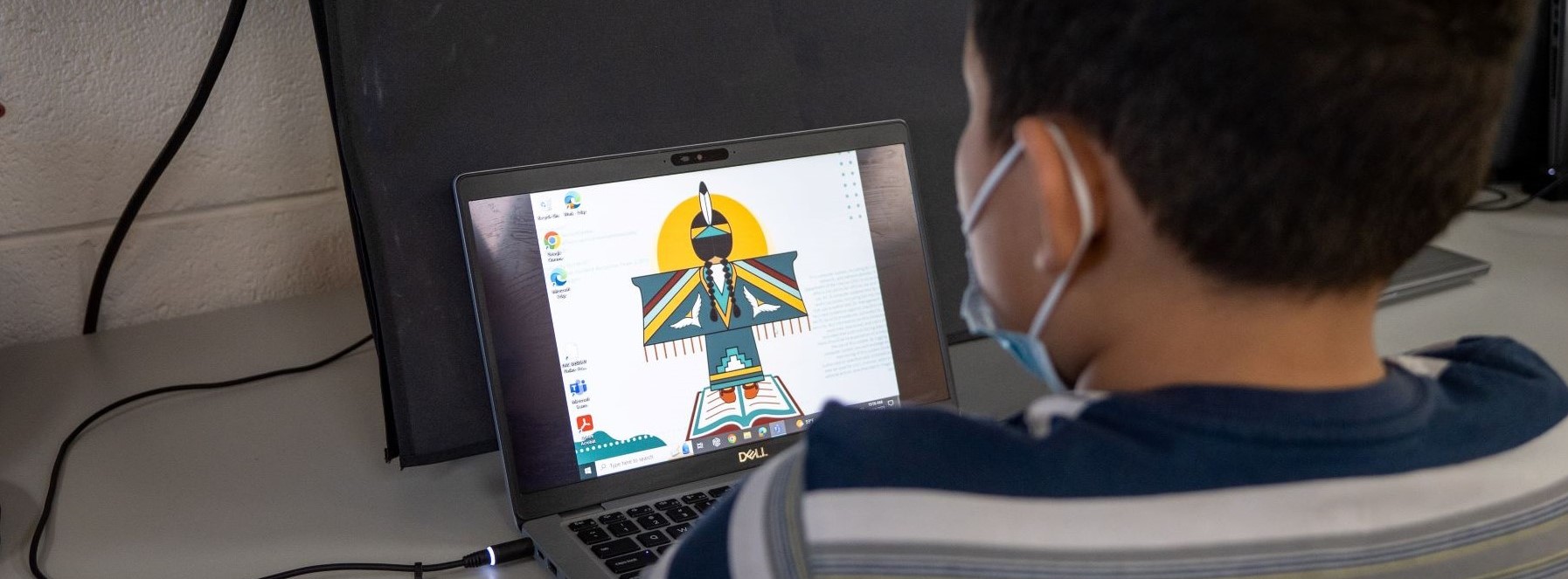 Student working on laptop in computer lab